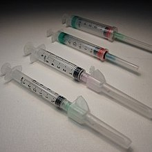 several syringes arranged on a white surface