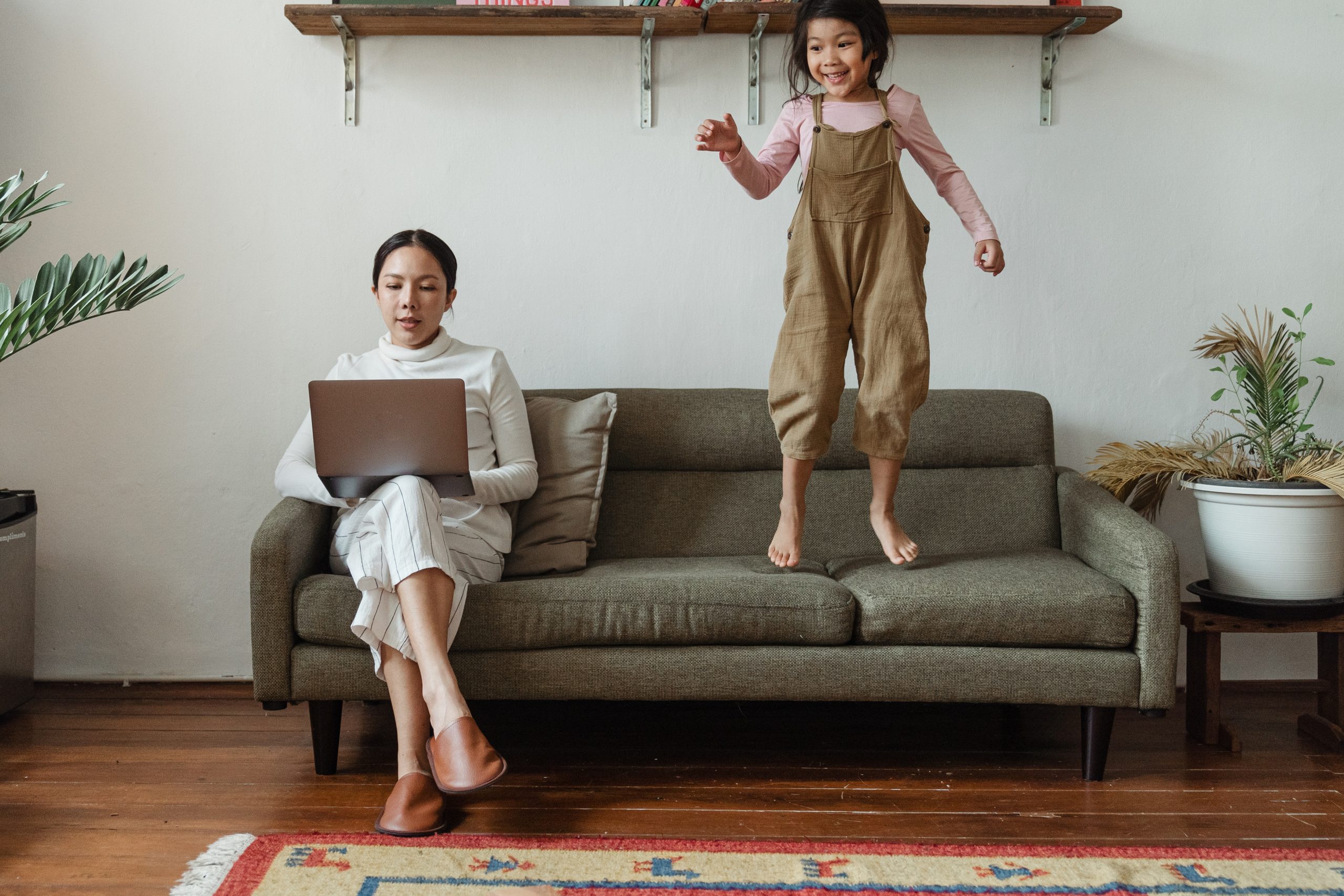 Parent trying to work at home while kid jumps on couch
