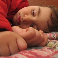 photo of a child sleeping in bed