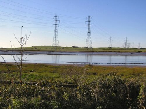 Power transmission towers against a clear sky