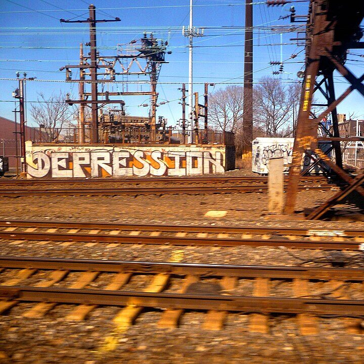 Graffiti of depression on a wall next to train tracks